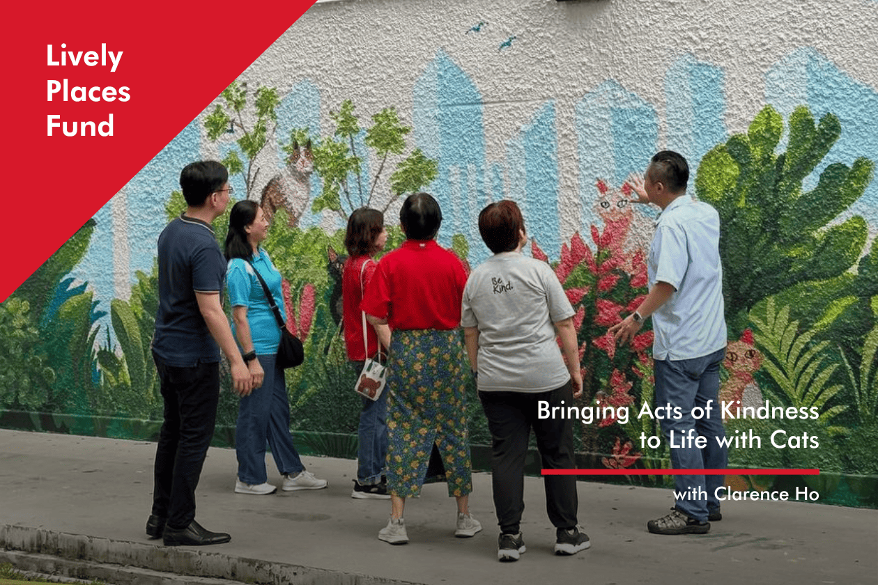 Artist Clarence Ho admiring the mural with fellow contributors who worked on 'Cats and Kindness'